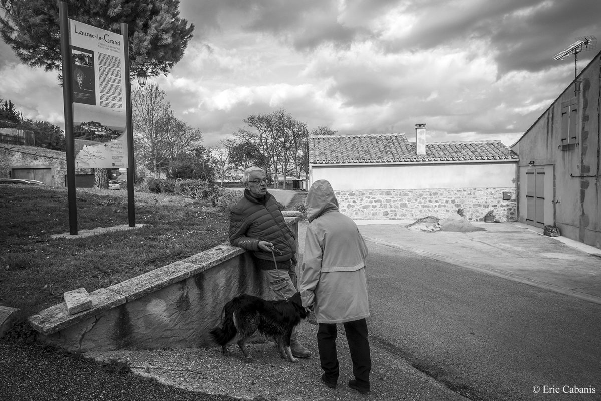 Deux habitants discutent à l'entrée du village de Laurac en mars 2020